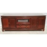 Modern Chinese hardwood lounge unit, rectangular top above assorted drawers and cupboard doors,