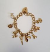 9ct gold padlock charm bracelet with eight gold coloured charms, 20g in total approx.