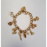 9ct gold padlock charm bracelet with eight gold coloured charms, 20g in total approx.