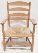 Low oak framed ladderback chair with rush seating