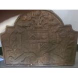 Cast iron fireback with armorial decoration