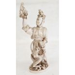 Japanese Meiji period carved ivory figure of a standing sennin holding aloft a figure of Kwannon