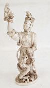 Japanese Meiji period carved ivory figure of a standing sennin holding aloft a figure of Kwannon