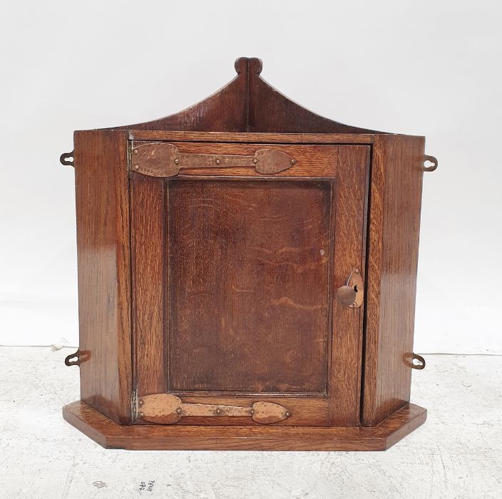 Art Nouveau style oak wall hanging corner cupboard with copper hinges and escutcheon