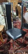 Set of four modern black leatherette and chrome effect dining chairs