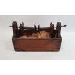 19th century winder fitted with two wooden spools over a pine base, 26cm long