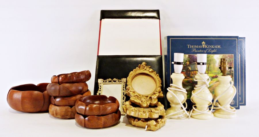 Three alabaster table lamps, a graduated set of teak serving bowls, various gilt picture frames