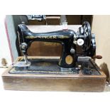 Vintage Singer sewing machine together with a sewing seat and contents of cotton reels, etc (2)