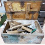 Wooden tool box containing various tools to include hammers, saws, etc.