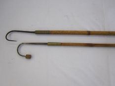 Two fishing gaffs with long brass and wooden handles, one stamped Hardy bros Makers, Alnwick, the
