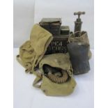 Three WWII gas masks, an ammunition box, a pump, a rucksack, two metal boxes of film cartridges, a