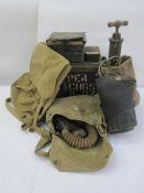 Three WWII gas masks, an ammunition box, a pump, a rucksack, two metal boxes of film cartridges, a
