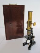 Mahogany cased microscope with various glass slides (mostly empty) and set of boxed glass circles