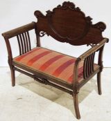 Early 20th century mahogany two-seat bench with carved and shaped backsplat, red upholstered seat,