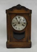 Early 20th century mahogany bracket clock with Roman numerals to the steel dial, on plinth base