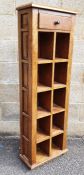 Modern Eastern hardwood narrow shelving unit, the rectangular top above single drawer, above open