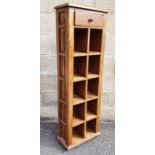 Modern Eastern hardwood narrow shelving unit, the rectangular top above single drawer, above open