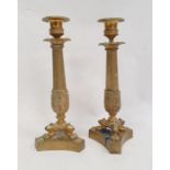 Pair brass candlesticks, each with beaded sconce, petal border to the reeded acanthus decorated