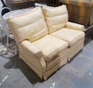 Modern two-seat sofa in yellow upholstery