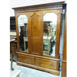 Early 20th century two-door mahogany wardrobe, the moulded cornice with blind fretwork carving,
