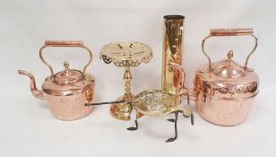 Two copper kettles, a brass trivet with royal cipher, a set of five graduated copper saucepans
