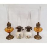 Two pottery and two brass and glass oil lamps (4)