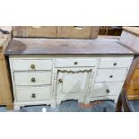 Pine-topped sideboard, the cream painted base with seven drawers and single cupboard door, the whole