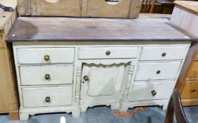 Pine-topped sideboard, the cream painted base with seven drawers and single cupboard door, the whole