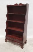 20th century mahogany waterfall bookcase with two drawers under, on ogee bracket feet, 77cm x