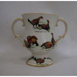 Ceramic two-handled trophy cup decorated with fighting birds 'A Challenge', 'A Knock Down Blow',