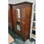 Early 20th century mahogany single mirrored door wardrobe, moulded cornice above the mirrored