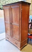 Early 20th century mahogany two-door wardrobe with blind fretwork carved decoration to the doors,