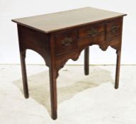 Georgian-style oak lowboy, the rectangular top with moulded edge above three drawers, shaped