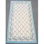 Three modern rugs, cream ground with blue ribbon trellis decoration, various sizes