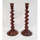 Pair of stained and turned wood candlesticks, each with spirally turned column, 44cm high (2)