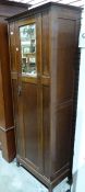 Narrow oak wardrobe with mirrored door, on stile supports, 64cm x 180cm