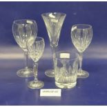 Four Waterford cut tumblers, oval medallion and bow decorated, five matching flared champagne flutes