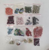 Assorted glass and other beads, loose in bags and a wooden bowl