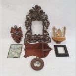 Metal ornate photograph frame with cherub surmount, carved treen and other items