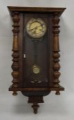 Walnut-cased Vienna-type regulator clock with Roman numerals to the dial