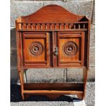 James Shoolbred of London wall-hanging cabinet, the arched back above spindle turned gallery, two