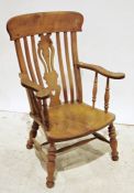 Elm-seated low armchair with carved and pierced shaped backsplat, on turned supports