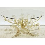 Modern coffee table with glass top and Italian-style cream painted floral spray base, 85cm diameter