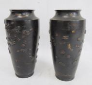 Pair of Japanese and partly gilded bronze vases, each shouldered and tapering, embossed with birds