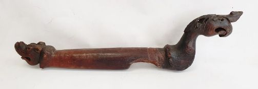 Carved hardwood boat tiller, probably 18th century, the long wooden tiller carved with a griffin