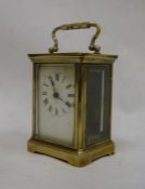 Brass and glass-cased carriage clock with handle