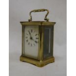 Brass and glass-cased carriage clock with handle