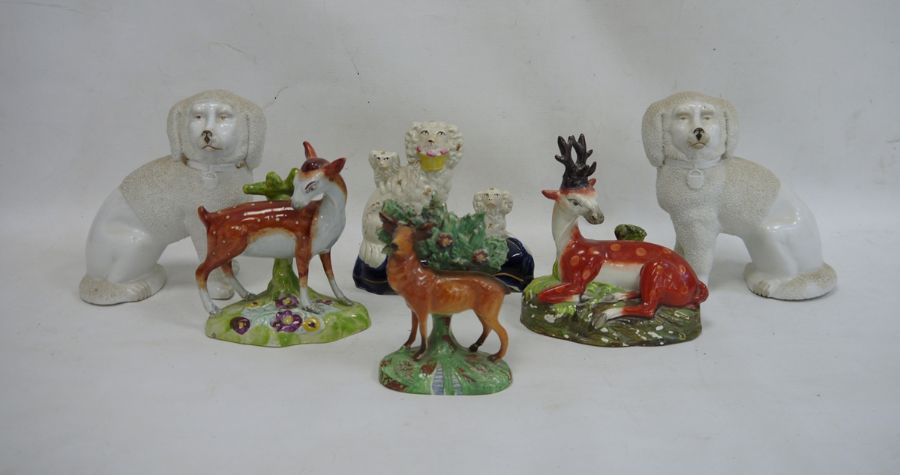 Staffordshire pottery deer, another stag, a spaniel group, a stag with bocage and a pair of china