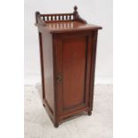 Early 20th century walnut pot cupboard, the part galleried top above the moulded edge, single