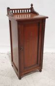 Early 20th century walnut pot cupboard, the part galleried top above the moulded edge, single